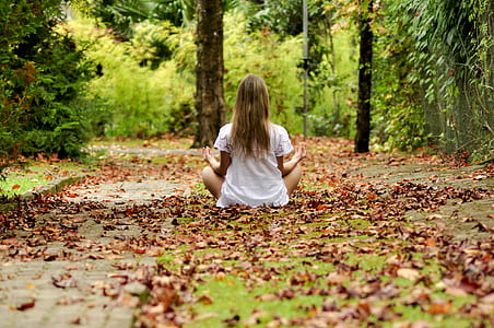 woman wearing white top meditating thumbnail