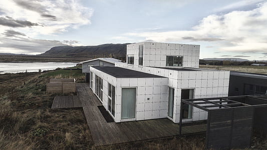 white and black concrete house on grass thumbnail