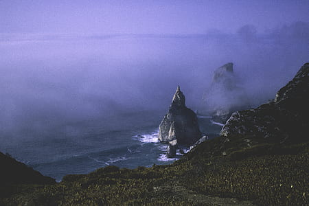 photo of body of water near land formation thumbnail