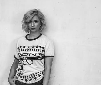 Woman Wearing White Labeled Shirt in Grayscale Photography thumbnail