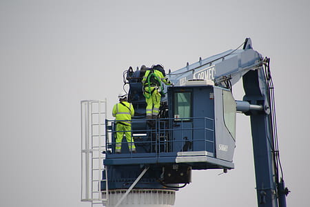 two men operating excavator thumbnail