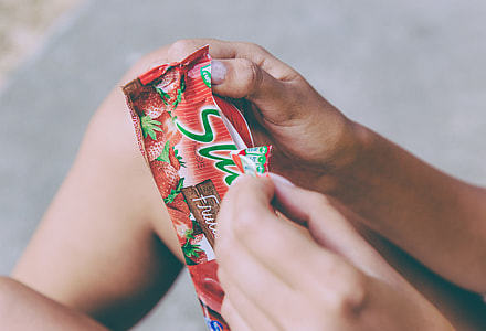 person holding strawberry flavored snacks thumbnail