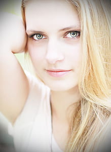 portrait photography of woman in white cap-sleeved shirt thumbnail
