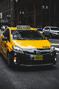 yellow and black Toyota taxi cab on the road thumbnail
