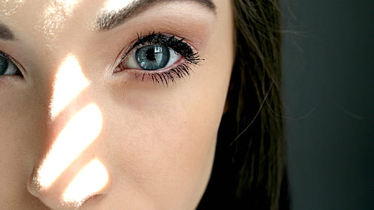 close up photography of woman with blue eyes thumbnail