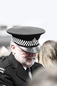 man in black peak cap selective-focus photography thumbnail
