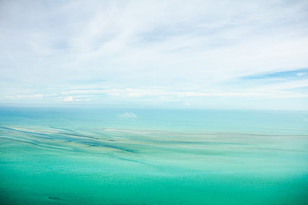 body of water under cloudy sky thumbnail