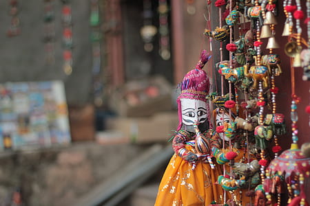 close-up photography of yellow and brown doll thumbnail