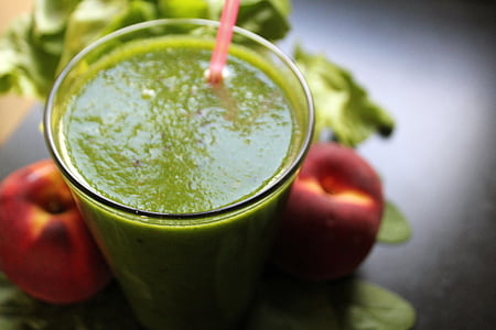 selective photo of green liquid filled clear glass with red straw thumbnail