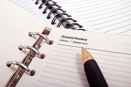 close-up photo of pen on top of opened notebook thumbnail