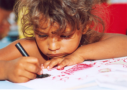 girl drawing during daytime thumbnail