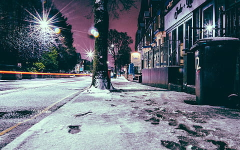 snow footprints on sidewalk during night time thumbnail