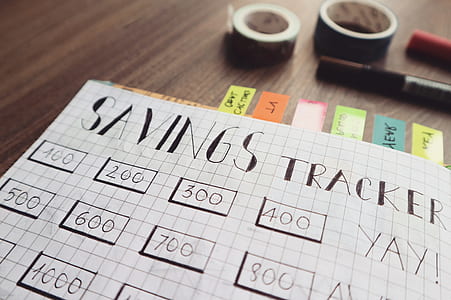 Savings Tracker on Brown Wooden Surface thumbnail