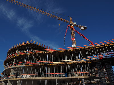 brown tower crane under blue sky thumbnail