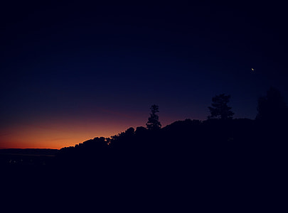 silhouette of mountain during night time thumbnail