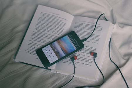 black smartphone on top of white book thumbnail
