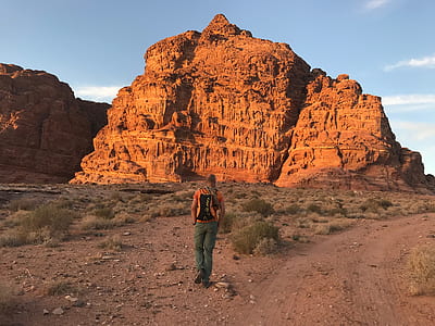 Person Wearing Orange Shirt and Green Pants thumbnail