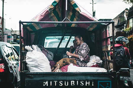 woman sitting at the back of a truck thumbnail