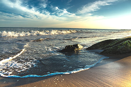 time-lapse photography of waves splashing on seashore thumbnail