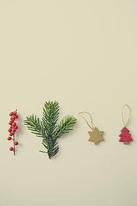 four assorted-color Christmas tree hanging decors on white surface thumbnail