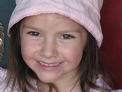 closeup photo of girl wearing pink laced cap thumbnail