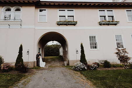 man and woman standing near wall thumbnail