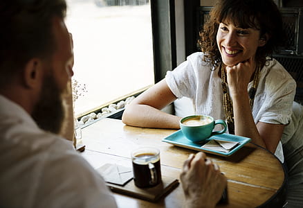 man and woman dating while smiling at eachother thumbnail