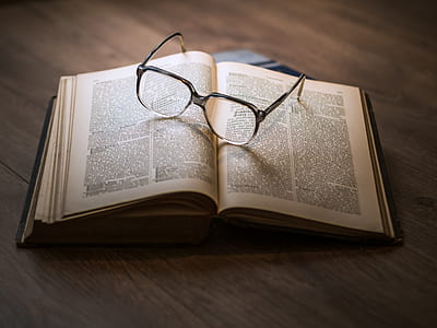 grey framed eyeglasses on book thumbnail