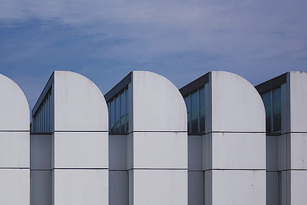 white concrete building under blue cloudy sky thumbnail
