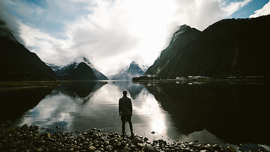 silhouette of person in front of body of water during daytime thumbnail