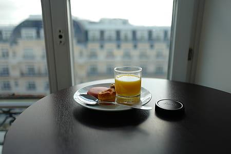 selective focus photography of glass of tea and bread on plate thumbnail