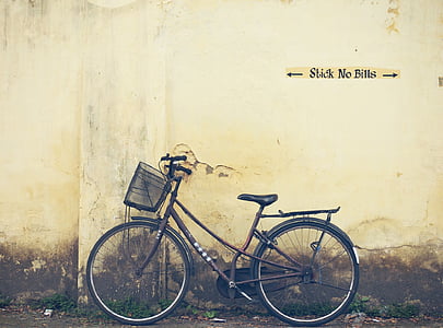 brown bike parked near wall thumbnail