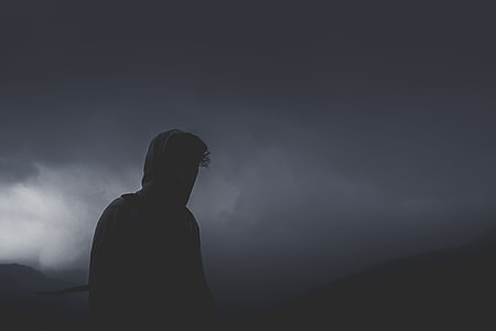 silhouette of man standing during black clouds thumbnail