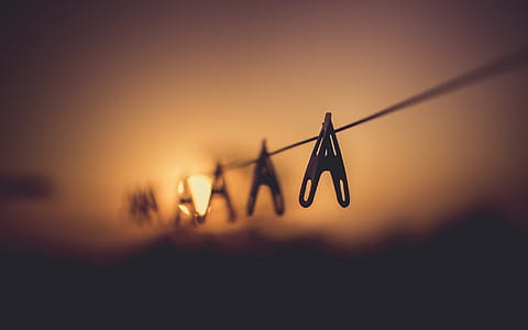 Shallow Focus Photography of Wooden Clothes Clip on Clothes String Rack thumbnail