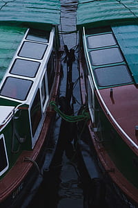 two brown-and-green water vessels on harbor thumbnail
