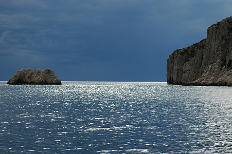 landscape photo of boulders on body of water thumbnail