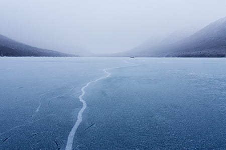 aerial photography of river under white skies thumbnail