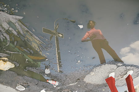Woman Standing on Ground Surrounded With Water thumbnail