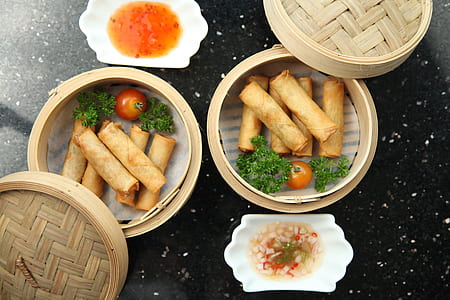 two round brown container with spring rolls thumbnail