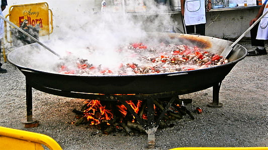 person cooking meat dish in wok thumbnail
