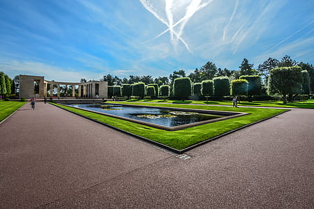 panoramic photography of green grass and brown concrete house thumbnail