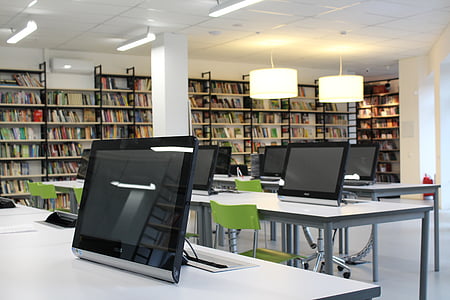 black flat screen computer monitors on white tables thumbnail
