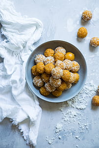 orange pastry with white sprinkles in bowl thumbnail