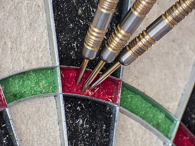 three silver dart pins on dartboard thumbnail