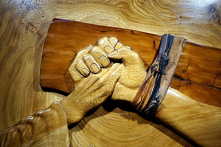 shallow photography of carved wood holding hands thumbnail