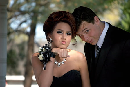 man and woman posing for picture taking thumbnail