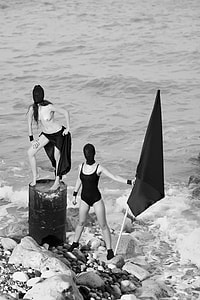 grayscale photo of woman holding flag thumbnail