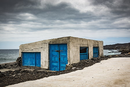 white and blue concrete building nearby sea thumbnail