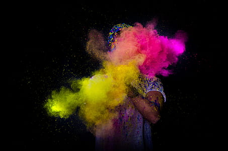 person clapping a colored powders against black background thumbnail