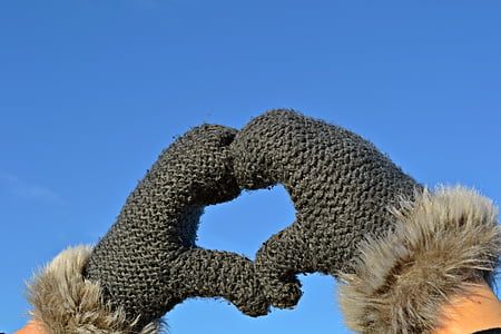 person making heart wearing black gloves thumbnail